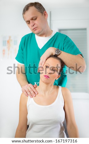 Chiropractor adjusting neck muscles