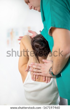 Chiropractor massage the female patient spine and back