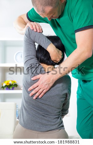 Chiropractor massage the female patient spine and back