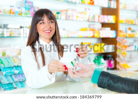 Patient giving a prescription to a smiling pharmacist