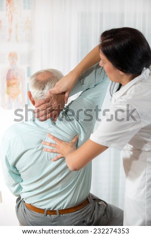 Chiropractic: Chiropractor examining senior man at office
