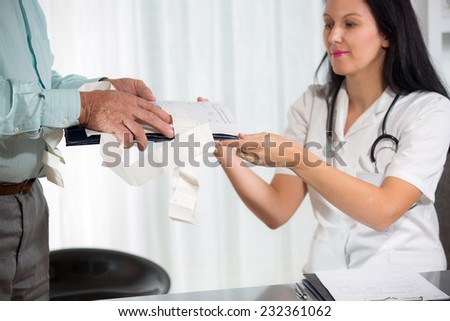 Female doctor with male patient. Doctor taking documentation from patient