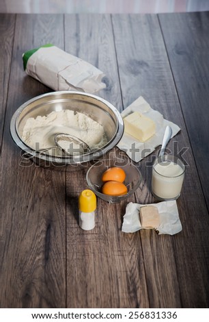 Baking cake in rural kitchen -  ingredients (eggs, flour, milk, butter,ferment, salt)