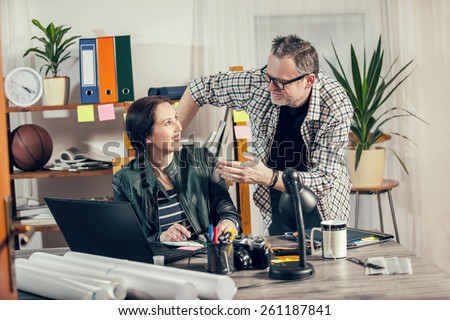 Two hipster managers working on laptop. Small Business Owner. Selective focus