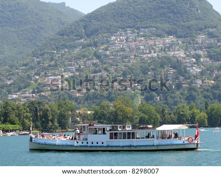 Cruiser ship with tourists on board. Lake Lugano, Switzerland