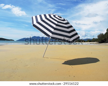 Striped umbrella on a sandy beach of Langkawi island
