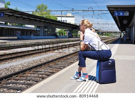 Girl at the railway station waiting for a train