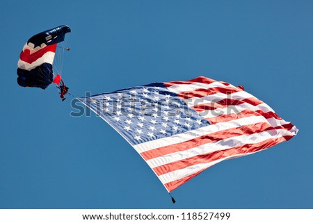 WASHINGTON DC - MAY 8:A skydiver Paul McCowan with US flag parachuting at the Joint Services Open House airshow on May 8,2012. It is the second largest known flyable American flag in existence.