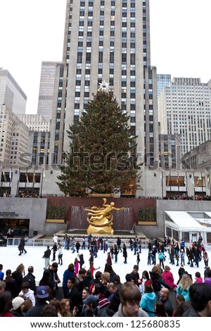 NEW YORK - DECEMBER 26: The Rockefeller Center Christmas Tree and statue of Prometheus above the ice rink on December 26 2012 in Manhattan New York. Rockefeller Center is a National Historic Landmark