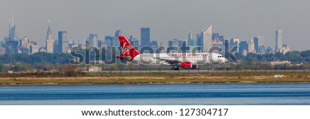 NEW YORK - DECEMBER 6: Airbus A320 Virgin landing on JFK Airport in New York on December 6, 2012. JFK Is rated 4th biggest American Airport, Call sign used by Virgin America is Redwood