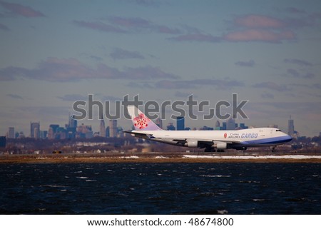 NEW YORK -MARCH 1:Boeing 747 Air China Cargo departing from JFK Airport on Runaway 4L with Manhattan skyline in background on March 1, 2010 in New York. Picture taken from Bayswater Park