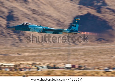 LAS VEGAS - NOVEMBER 14:F-15 Eagle performing full afterburner low pass in Las Vegas, USA on November 14, 2010. Plane is wearing livery called Aggressor, during the exercises he play aggressors role