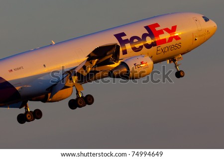 NEW YORK - MARCH 8: MD-10 approaches JFK Airport located in New York, USA on March 8, 2011. Fedex is the biggest shipping/cargo company in the world serve over 300 destinations worldwide