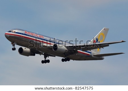 NEW YORK - MAY 16: A Boeing 777 American Airline approaches JFK in New York, USA on May 16, 2011. This plane wears a very special paint scheme called Yellow Ribbon - Support Our Troops\