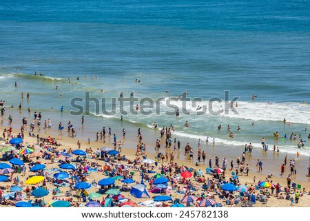 OCEAN CITY - JUNE 14: Crowded beach in Ocean City, MD on June 14, 2014. Ocean City, MD is a popular beach resorts on East Coast and one of the cleanest in the country.