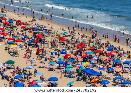 OCEAN CITY - JUNE 14: Crowded beach in Ocean City, MD on June 14, 2014. Ocean City, MD is a popular beach resorts on East Coast and one of the cleanest in the country.