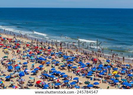 OCEAN CITY - JUNE 14: Beach full of people in Ocean City, MD on June 14, 2014 during OC Airshow. Ocean City, MD is a popular beach resort on East Coast and one of the cleanest in the country.