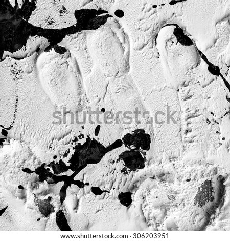 black paint smeared on white plastered wall