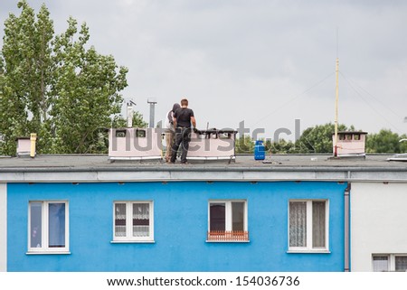 Builder worker at roof insulation work