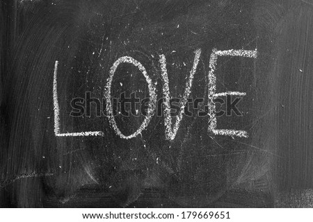 Blackboard writing on it with chalk - with the sign of love