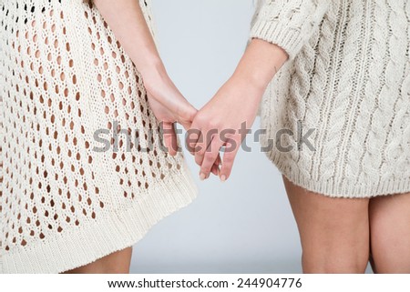 Two woman holding their hands, lesbian concept