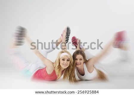 view of two fitness smiling girl
