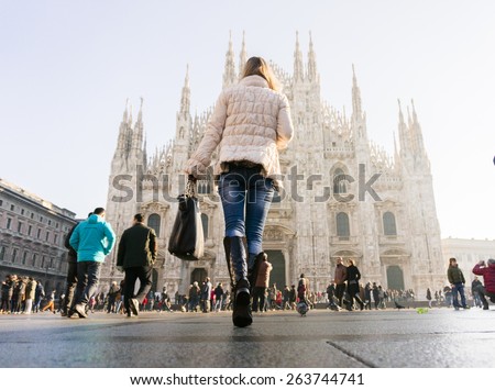 woman with bag in front of of Duomo di Milano (Milan Cathedral), Milan, Italy