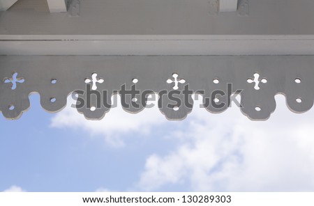 White painted antique wooden molding around veranda on old house