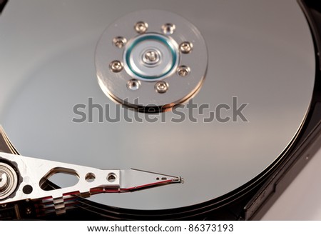 Magnetic disc inside a computer hd unit showing mirror surface of the magnetic discs and read write head