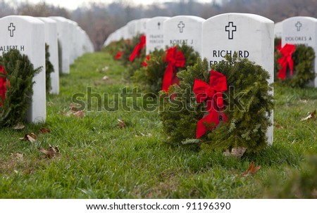 ARLINGTON, VA - DECEMBER 18: Christmas wreaths on gravestones in Arlington National Cemetery on December 18, 2011. The wreathes have been donated each year since 1992.