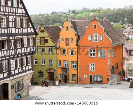 SCHWABISCH HALL, GERMANY - APRIL 26: Painted houses in town square as tourists walk into town on April 26, 2013. The Town Hall was inaugurated in 1735