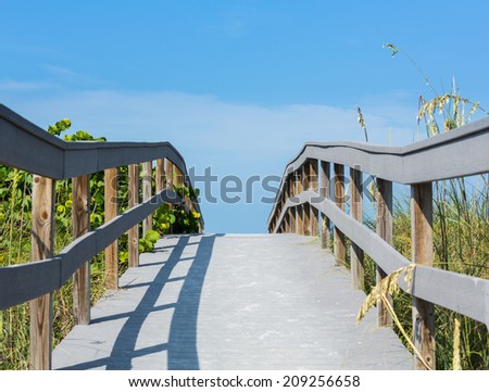 Wooden boardwalk to ocean among sea oats on Sunset Beach at southern tip of Treasure Island Florida on Gulf of Mexico