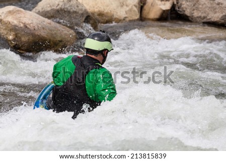 Expert male kayaker in short white water kayak in the rapids of River Arkansas at Buena Vista in Colorado