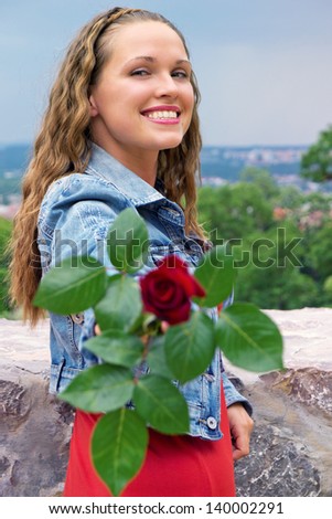 Rose for gift / Beautiful young woman show her rose to the camera