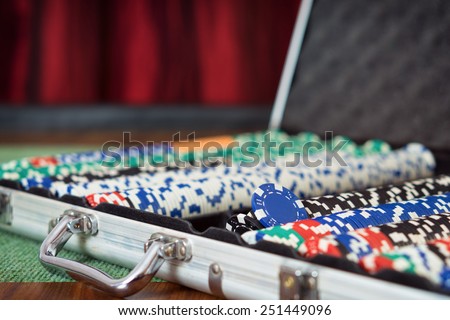 Suit case full of Poker chips / Casino table