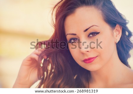 Cute, attractive woman, close up photo with color filters and some fine film grain added