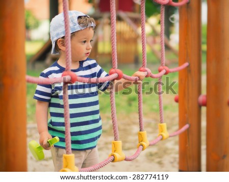Young boy / Little kid playing around the playground
