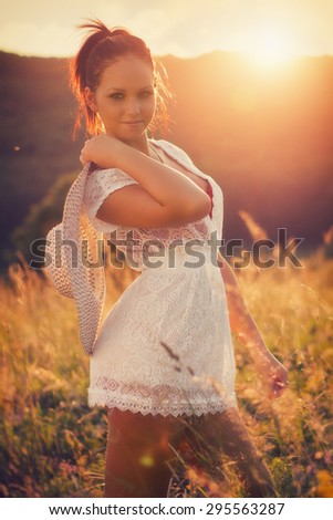 Summer fashion, Beautiful young women in the sunset, with custom white balance, color filters, and some fine film grain added