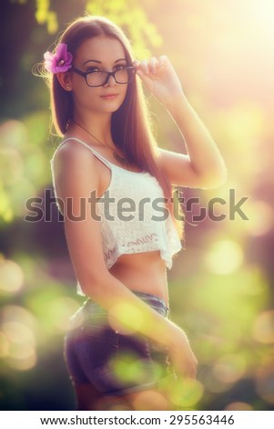 Summer fashion, Beautiful young women in the sunset, with custom white balance, color filters, soft focus effect, and some fine film grain added