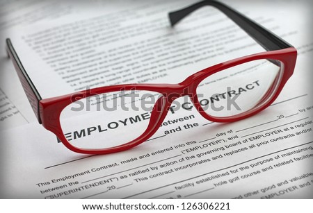 employment contract and female red glasses, close-up
