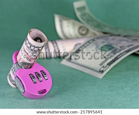 Concept of cash deposit - dollars with lock, on green backdrop