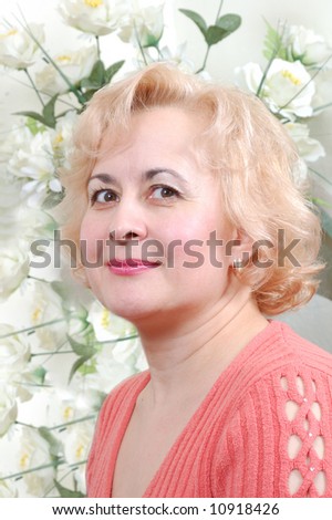 lady with happy eye against a background white flowers