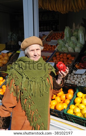 grandmother on market hold in hand vegetable