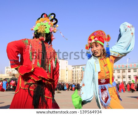 LUANNAN COUNTY - FEBRUARY 19: During the Chinese Lunar New Year, people wear colorful clothes, yangko dance performances in the streets on February 19, 2013, Luannan County, Hebei Province, China.