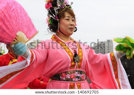 LUANNAN COUNTY - FEBRUARY 25: During the Chinese Lunar New Year, people wear colorful clothes, yangko dance performances in the streets, on February 25, 2013, Luannan County, Hebei Province, China.