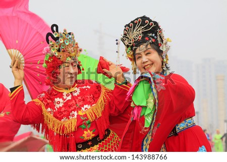 LUANNAN COUNTY - FEBRUARY 27: During the Chinese Lunar New Year, people wear colorful clothes, yangko dance performances in the streets, on February 27, 2013, Luannan County, Hebei Province, China.