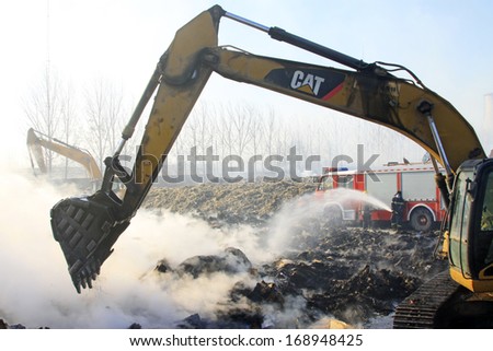 TANGSHAN - NOVEMBER 20: The excavators were clearing up rubbish after fire, November 20, 2013, Tangshan city, Hebei province, China.