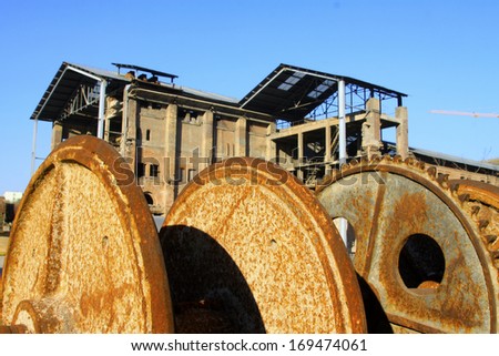 TANGSHAN - NOVEMBER 4: The gears and abandoned factories in the Qixin cement plant on november 4, 2013, tangshan city, hebei province, China.