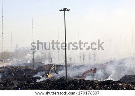 TANGSHAN - NOVEMBER 20: The excavators were clearing up rubbish after fire, November 20, 2013, tangshan city, hebei province, China.