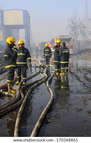 TANGSHAN - NOVEMBER 20: The prepare to leave the scene of the fire fighting vehicles and personnel after the fire, November 20, 2013, tangshan city, hebei province, China.